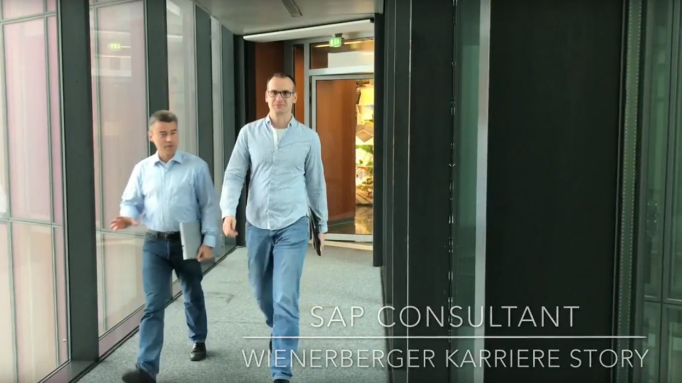 Two men walking in a hallway