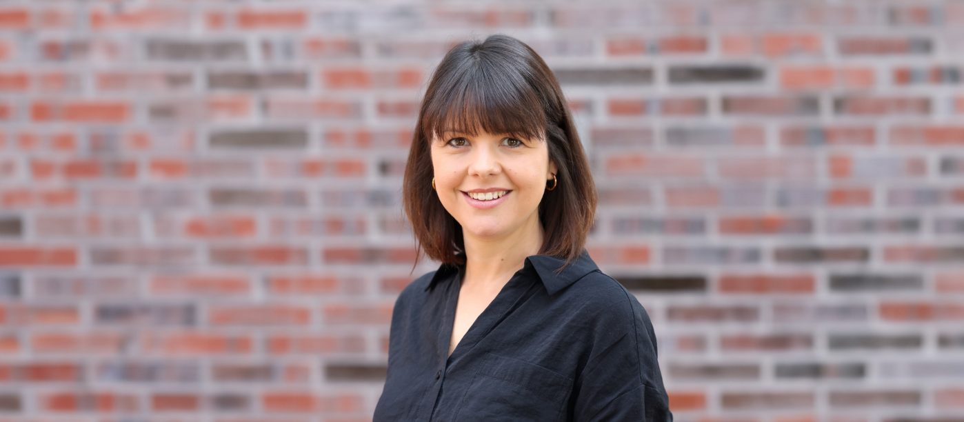woman with black hear on a railing in an office