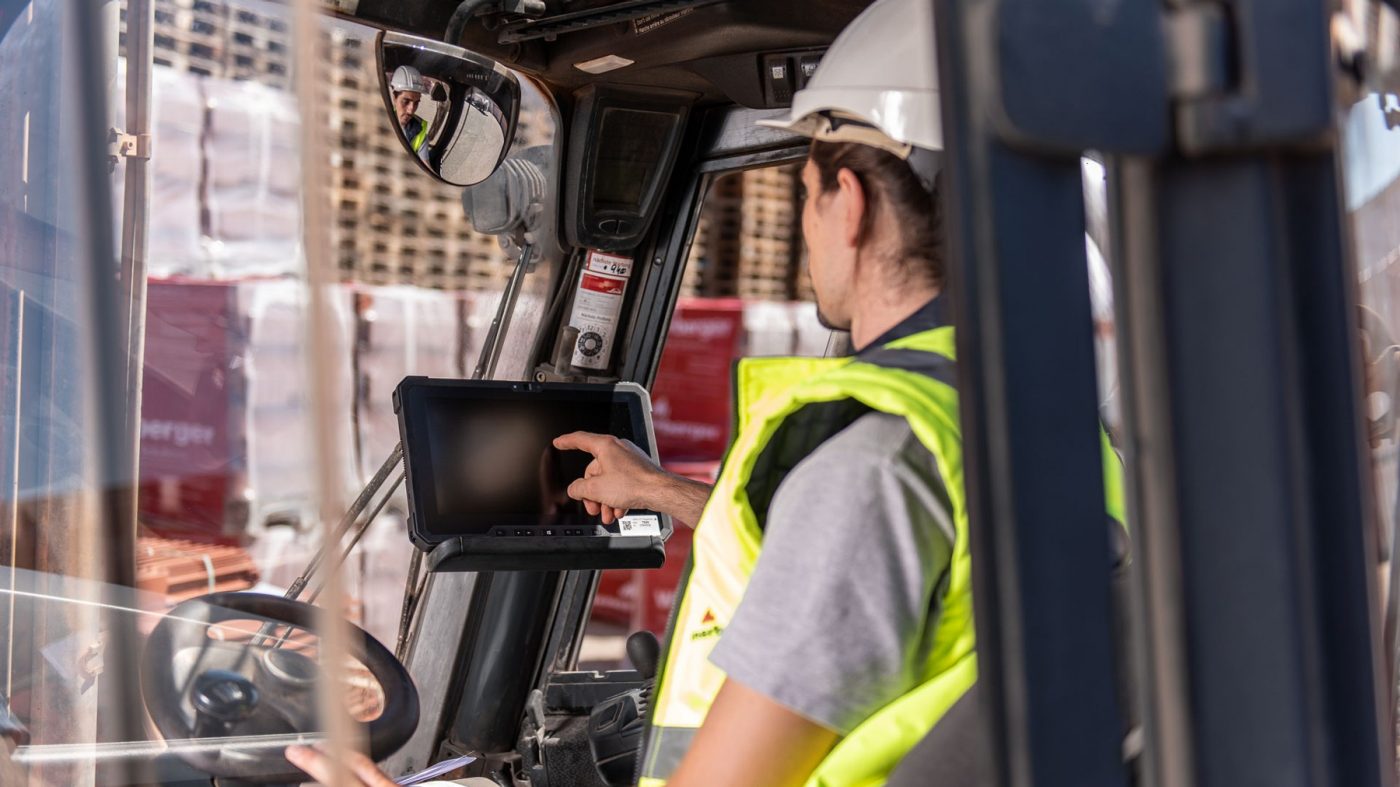 Man driving forklift on a stockyard